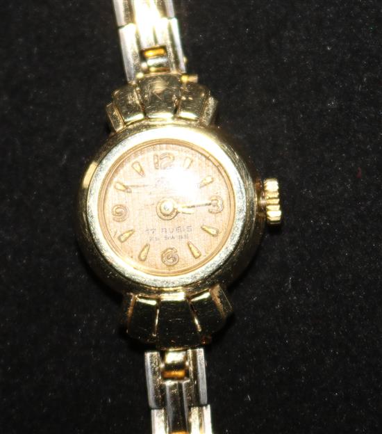 A ladys 14ct gold wrist watch, on a gilt metal bracelet.